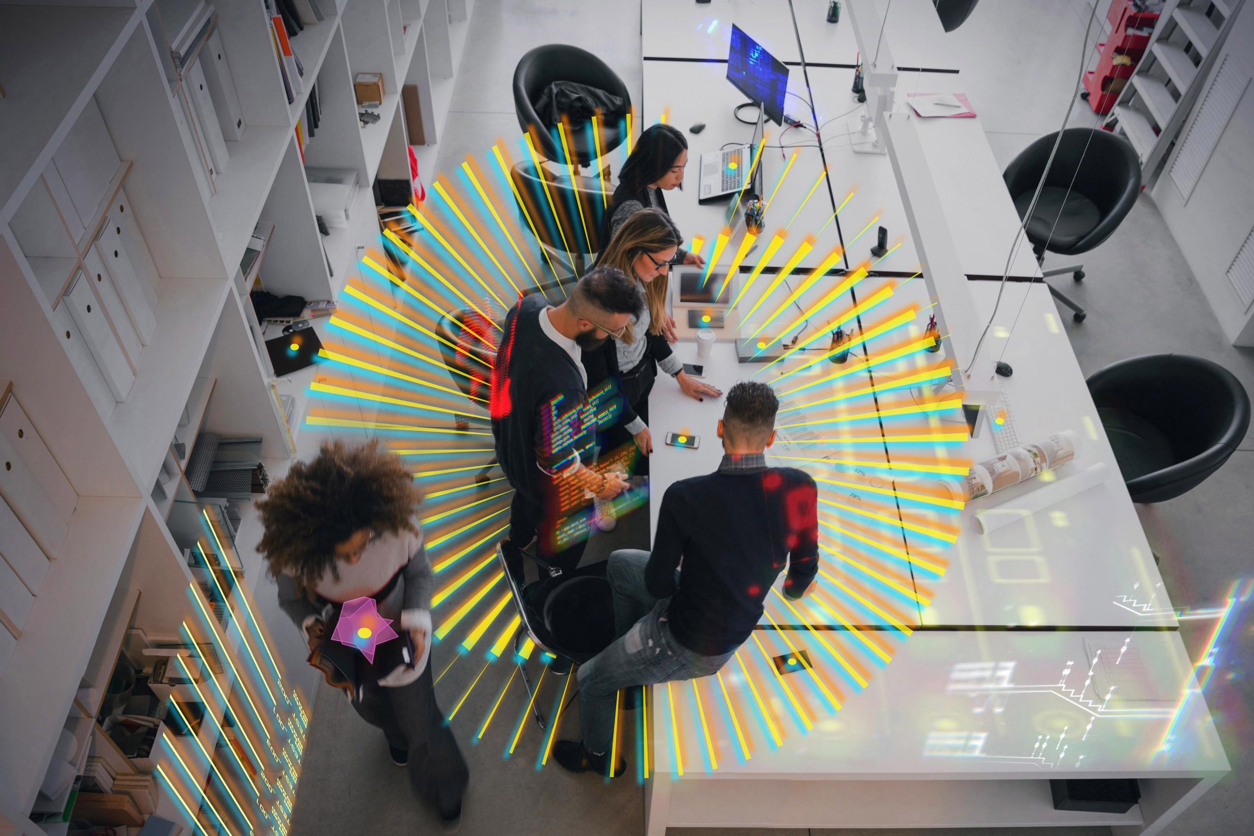 Architect team working on tech items. Overhead viewpoint.