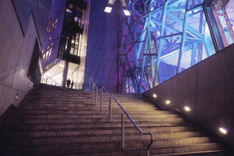 Stairway towards Federation Square with the illuminated Edge Theatre, Melbourne, Australia.